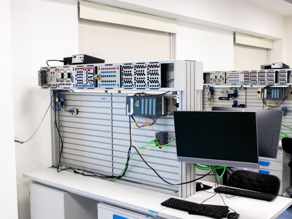 A contemporary office showcasing a server rack and computer workspace, ideal for tech and business settings.