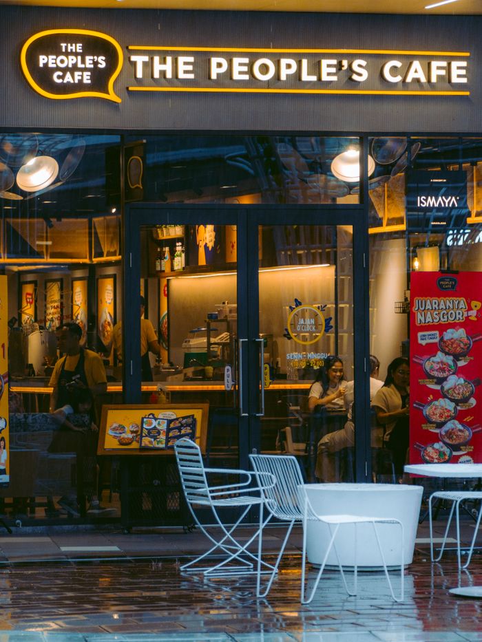 View of The People's Cafe in West Karawang, bustling with city life and vibrant decor.
