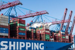 Shipping containers and cranes at Hamburg port showcasing global trade.