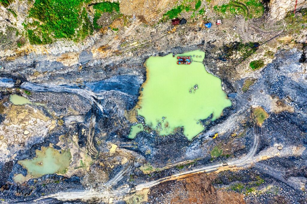 Capture of a quarry with vibrant green pools in Rumpin, Indonesia.